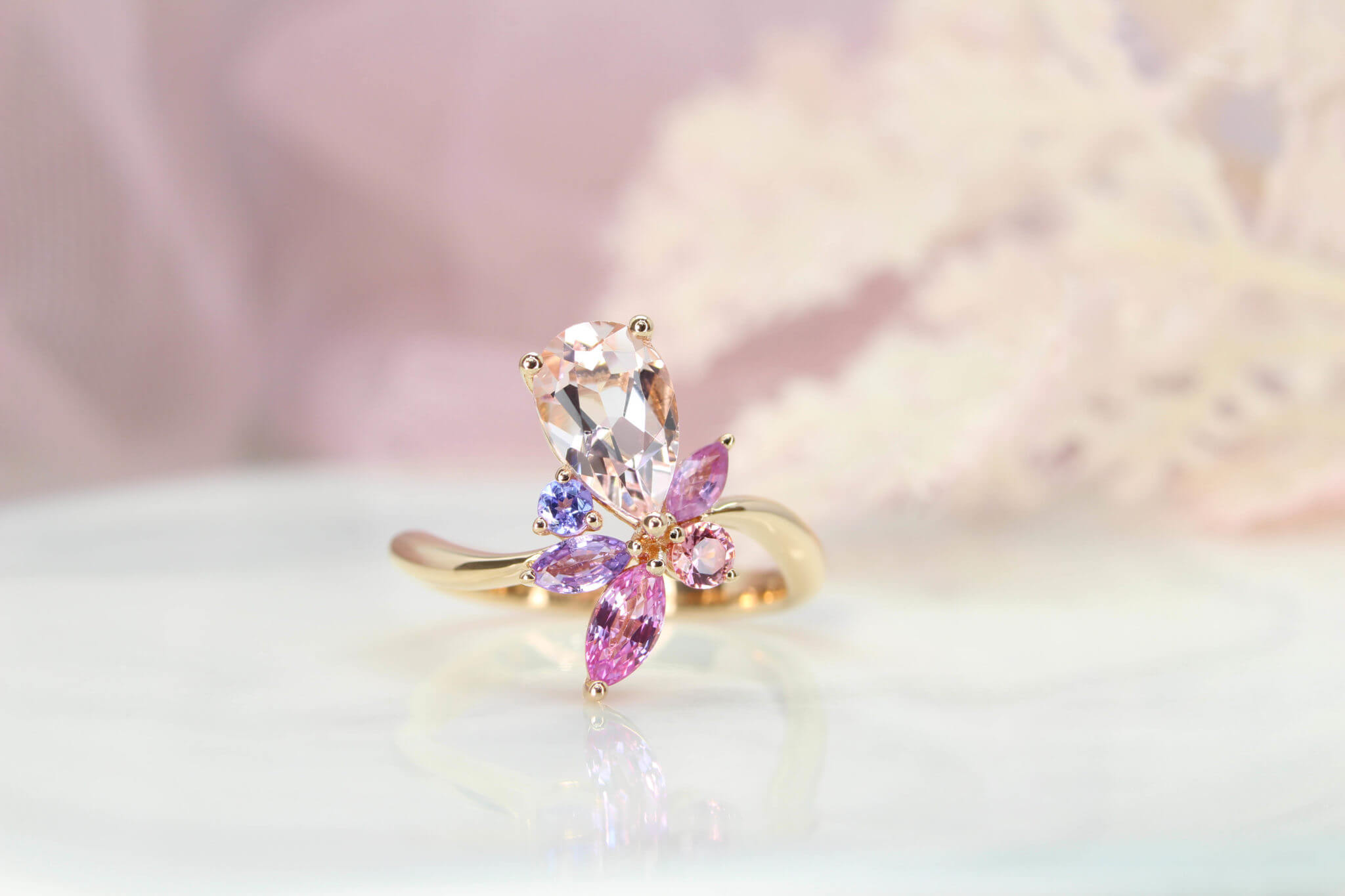 Floral Engagement Ring, customised with Morganite pear with orange and pink coloured shade, violet and pink sapphire in marquise shapes. Designed and crafted to a unique floral engagement ring | Local Singapore Jeweller customised engagement ring in floral design.
