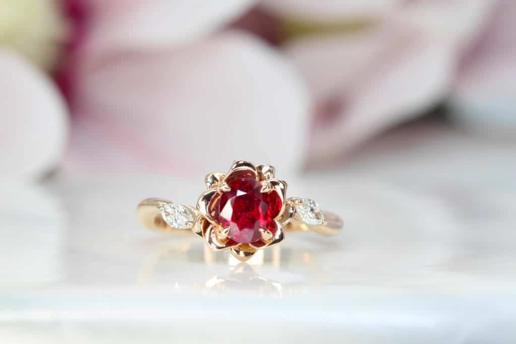 Engagement ring Ruby features an unheat vivid red ruby rare gemstone. Flora leaves in marquise diamonds and petals in rose gold surrounding the ruby Ring