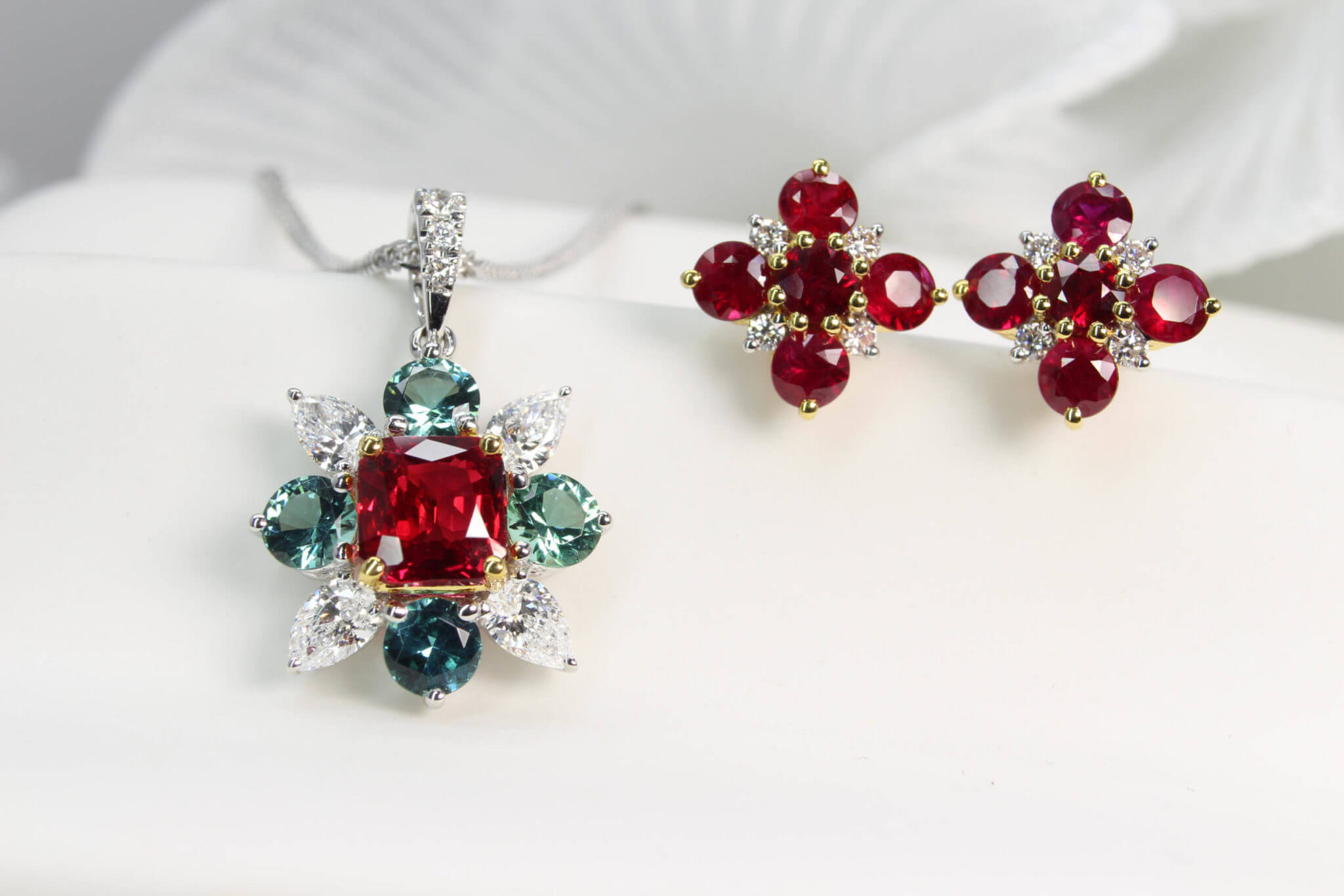 40th Anniversary Wedding Jewellery, Featuring unheated ruby depend clustered with round green tourmaline and pear diamond around the ruby gem. The cluster earring with ruby and diamond gems design and customised for a 40th anniversary wedding jewellery | Local Singapore Jeweller in ruby and coloured gemstone